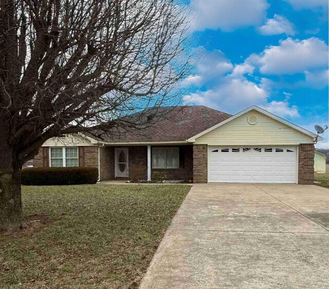 single story home featuring a front yard and a garage