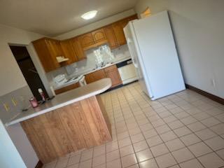 kitchen featuring white fridge and light tile patterned floors