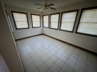 unfurnished sunroom with ceiling fan