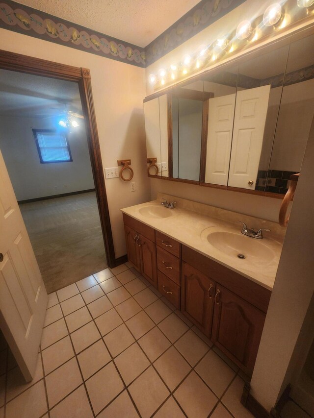 bathroom featuring tiled bath, a textured ceiling, toilet, and tile patterned floors