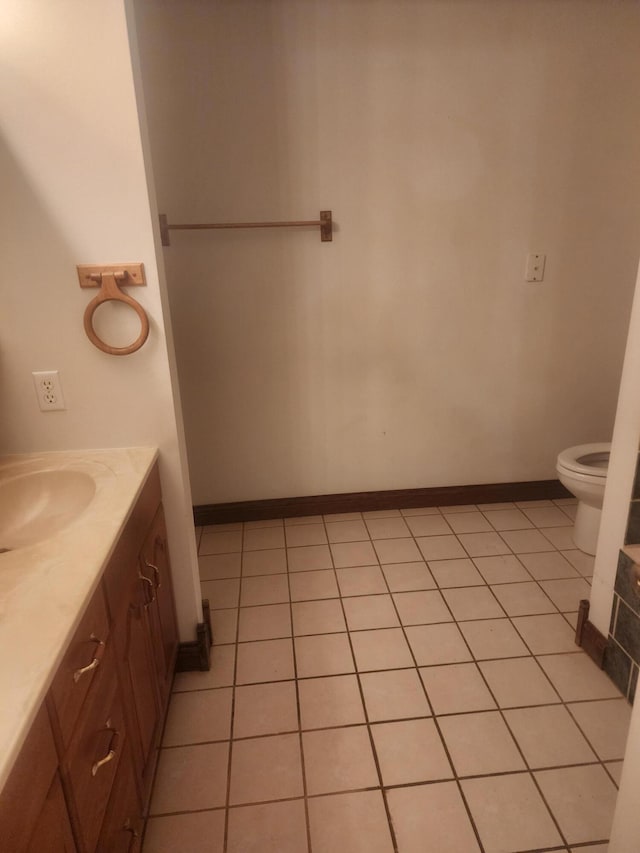 bathroom featuring vanity, toilet, and tile patterned flooring