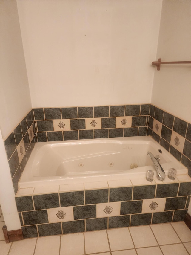 bathroom featuring tile patterned flooring and a relaxing tiled tub