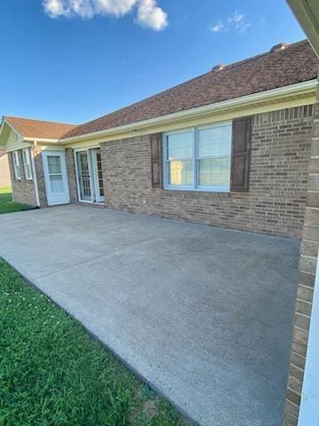 rear view of house with a yard and a patio area