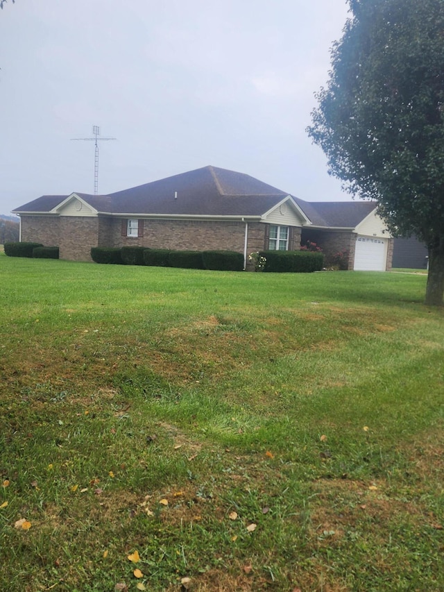 single story home featuring a garage and a front lawn