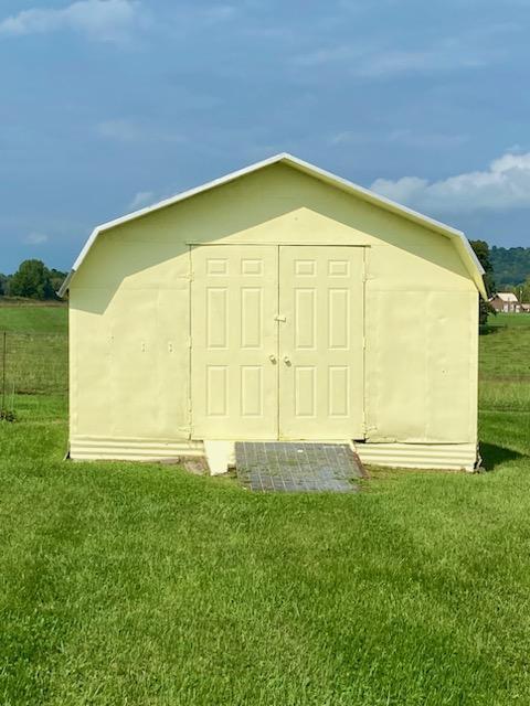 view of outbuilding with a lawn