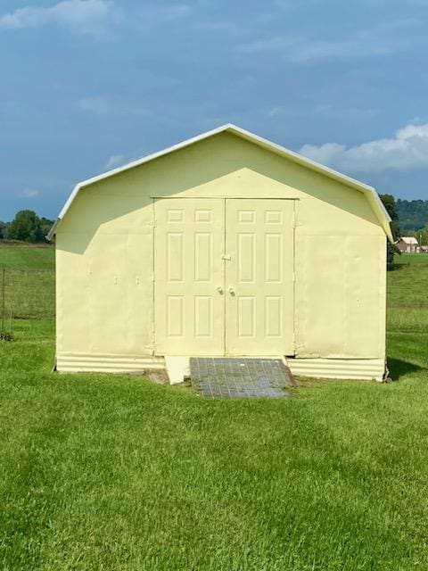 view of outbuilding featuring a lawn