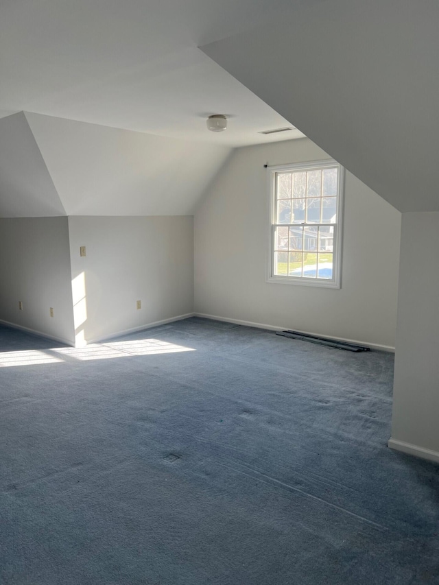 bonus room featuring vaulted ceiling, carpet, and baseboards