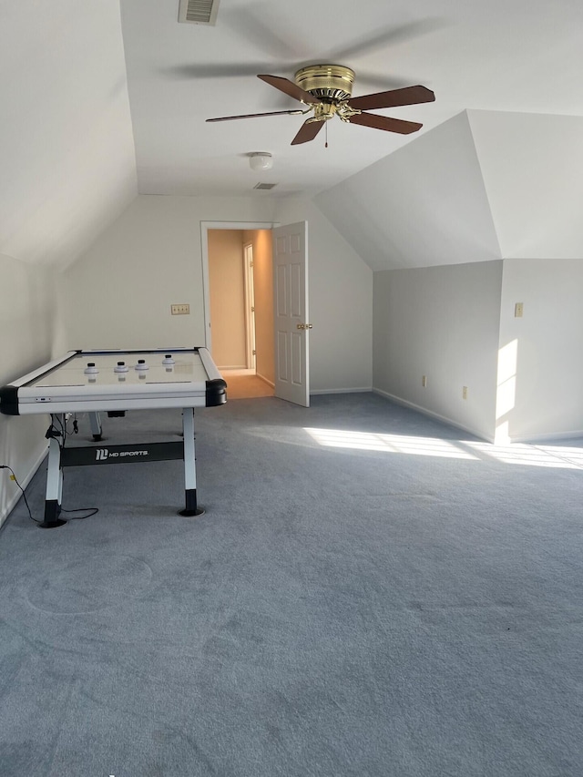 interior space with lofted ceiling, carpet, visible vents, and a ceiling fan