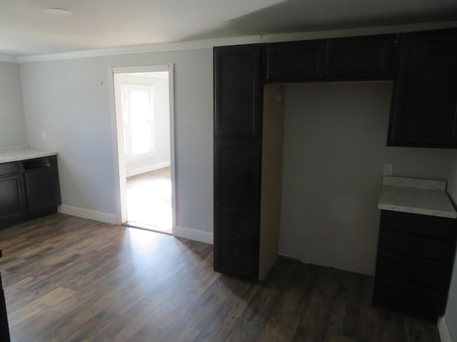 10 W Church St, Stanton, KY 40380 - kitchen with dark wood-style floors, crown molding, light countertops, and dark cabinetry