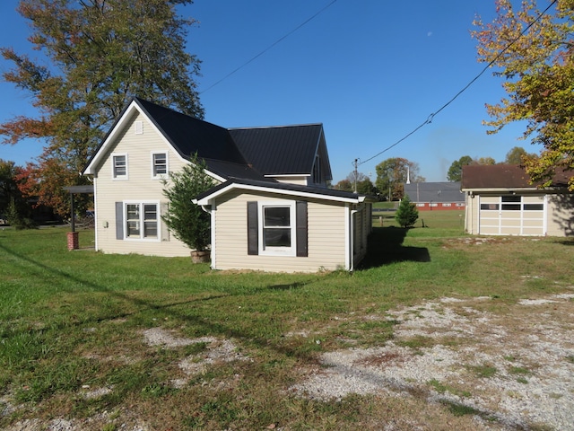 10 W Church St, Stanton, KY 40380 - view of side of property with a lawn, a garage, and a metal roof