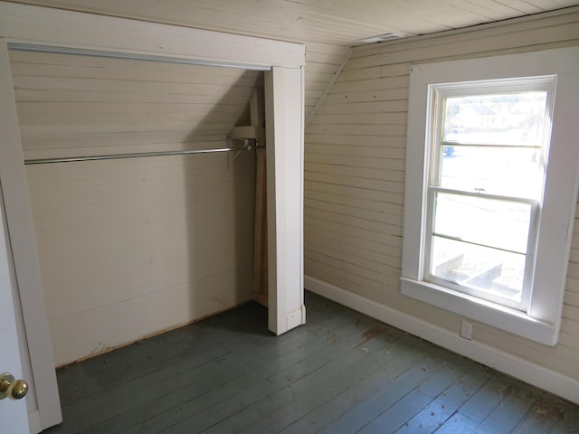 10 W Church St, Stanton, KY 40380 - unfurnished bedroom with wood-type flooring, multiple windows, a closet, lofted ceiling, and wooden walls