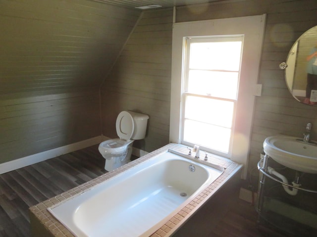 10 W Church St, Stanton, KY 40380 - bathroom featuring tiled tub, wood finished floors, and wooden walls
