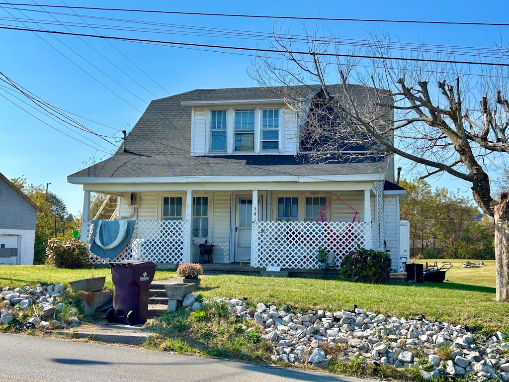 view of front of property with a front yard and covered porch