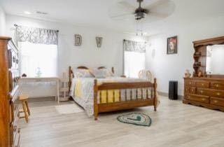 bedroom with light hardwood / wood-style floors and ceiling fan