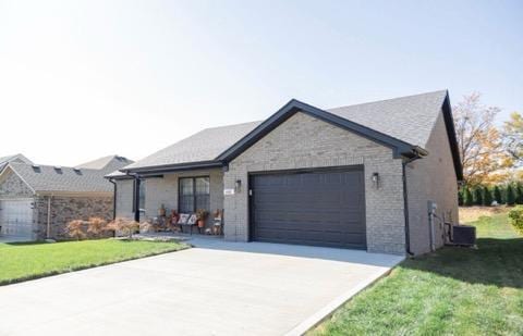 single story home featuring central AC, a garage, and a front lawn