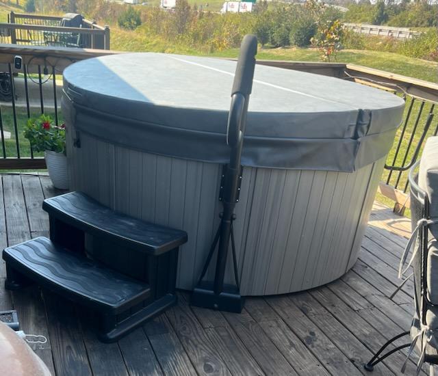 deck featuring a hot tub