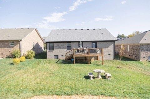 back of house featuring a yard and a deck