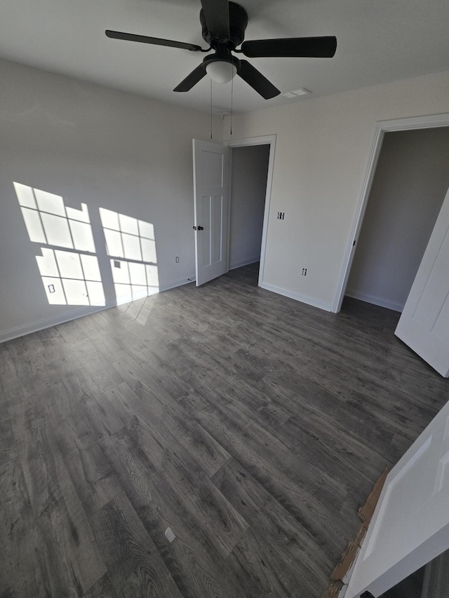 unfurnished room with dark hardwood / wood-style flooring