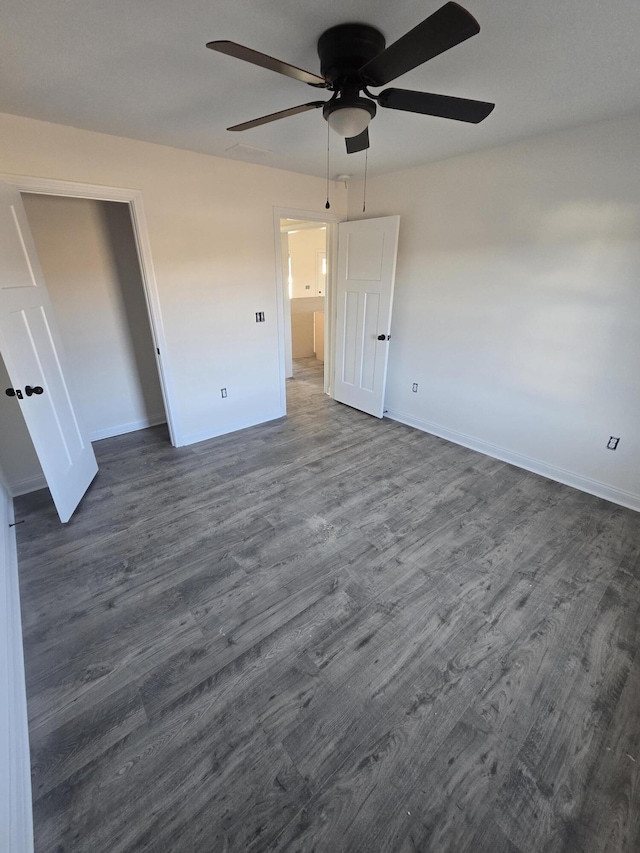 unfurnished bedroom with dark hardwood / wood-style flooring and ceiling fan