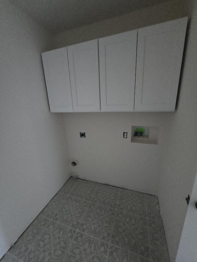 laundry area featuring cabinets, tile patterned flooring, electric dryer hookup, and washer hookup