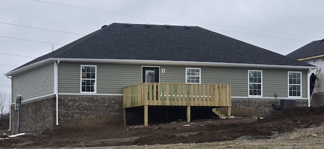 rear view of property featuring a deck and central air condition unit