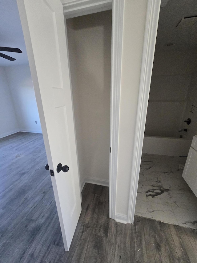 interior space with wood-type flooring and ceiling fan