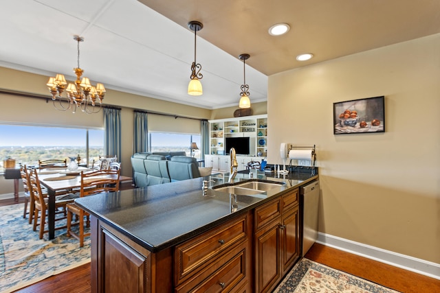 kitchen with an inviting chandelier, sink, stainless steel dishwasher, dark hardwood / wood-style floors, and decorative light fixtures