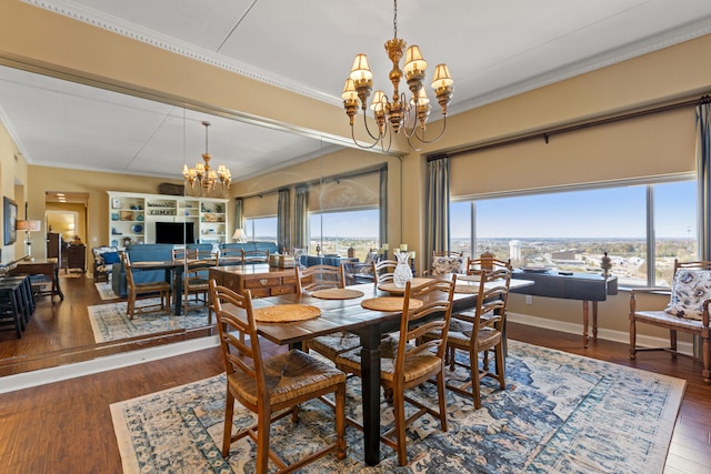 dining room featuring plenty of natural light, dark wood-type flooring, and a notable chandelier