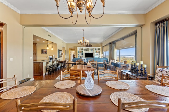 dining space featuring a notable chandelier, wood-type flooring, and ornamental molding