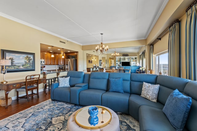 living room with hardwood / wood-style floors, crown molding, and a chandelier