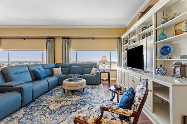 living room featuring wood-type flooring and crown molding