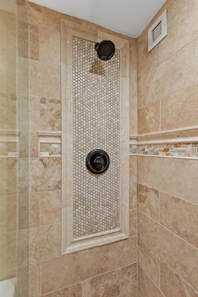 bathroom with tiled shower