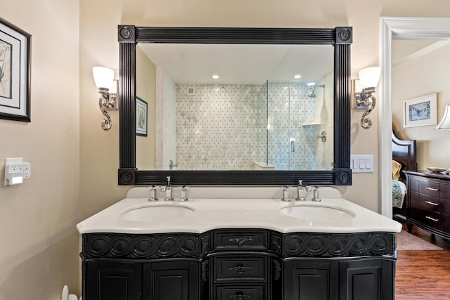 bathroom with wood-type flooring, vanity, and walk in shower