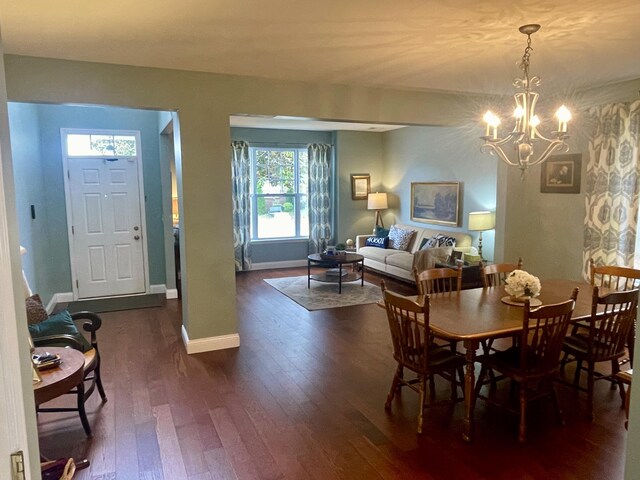 dining space featuring a notable chandelier and dark hardwood / wood-style flooring