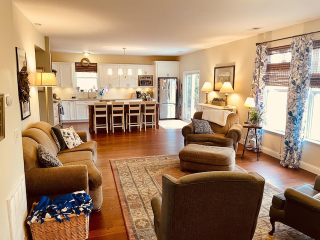 living room with sink and dark hardwood / wood-style floors