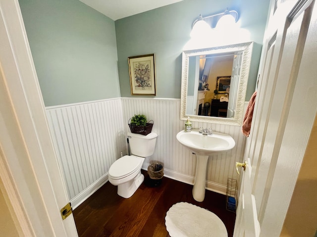 bathroom with hardwood / wood-style flooring, sink, and toilet