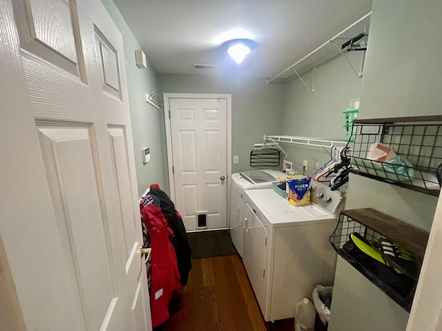 clothes washing area featuring independent washer and dryer and dark wood-type flooring