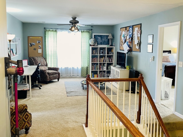 carpeted home office featuring ceiling fan