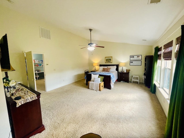 carpeted bedroom with ceiling fan and vaulted ceiling