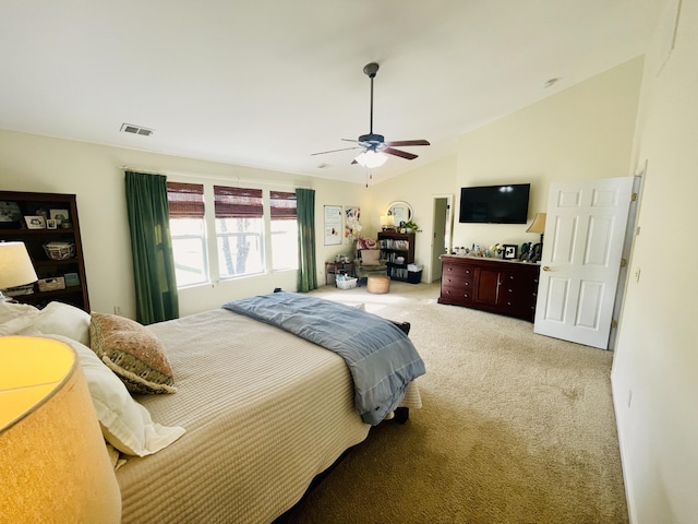 carpeted bedroom featuring vaulted ceiling and ceiling fan