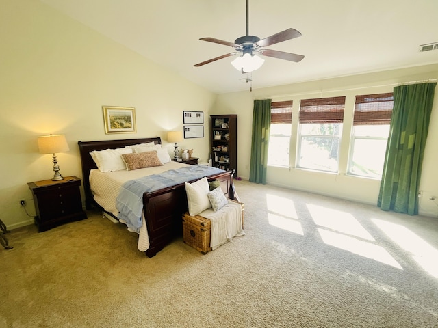 bedroom with ceiling fan, light carpet, and vaulted ceiling