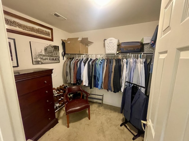 spacious closet featuring light colored carpet