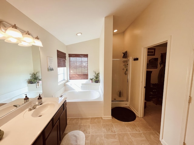 bathroom featuring vaulted ceiling, vanity, tile patterned floors, and shower with separate bathtub