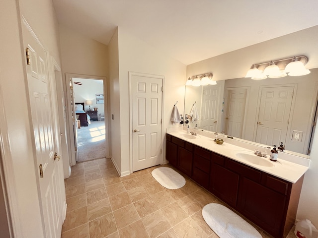 bathroom with vanity and lofted ceiling