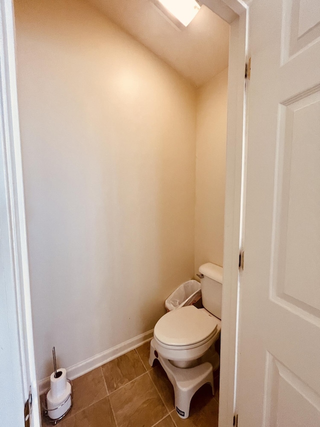 bathroom with toilet and tile patterned flooring