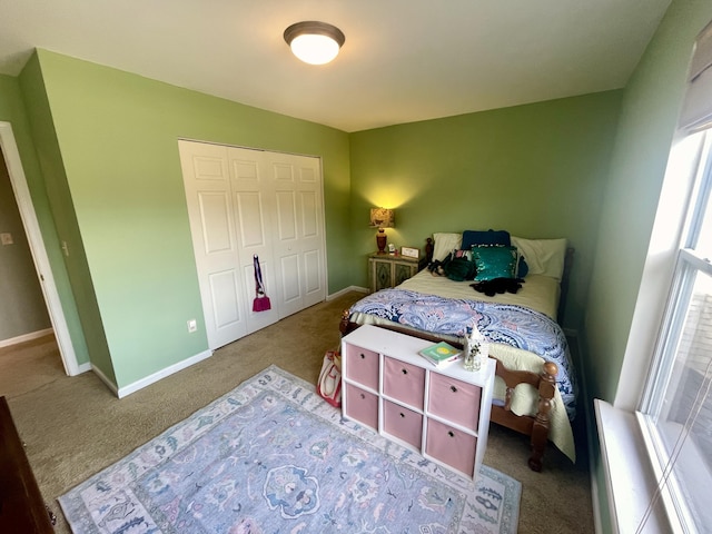 carpeted bedroom featuring a closet and multiple windows