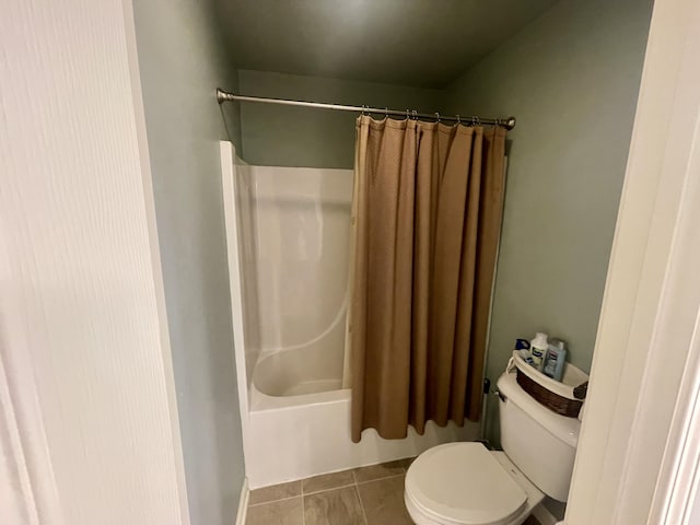 bathroom featuring shower / bath combo, toilet, and tile patterned floors