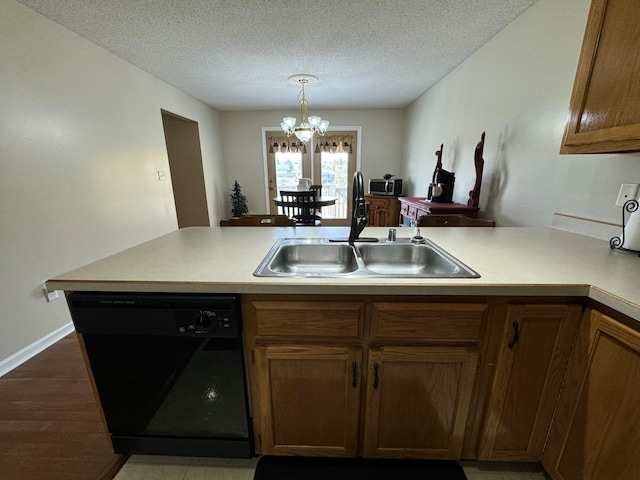 kitchen with dark hardwood / wood-style flooring, black dishwasher, kitchen peninsula, a notable chandelier, and sink