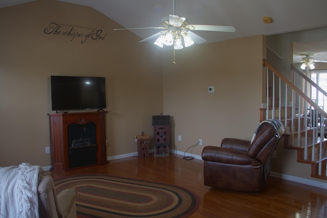 living room with hardwood / wood-style flooring, ceiling fan, and vaulted ceiling