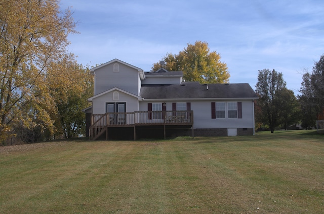 rear view of house with a wooden deck and a yard